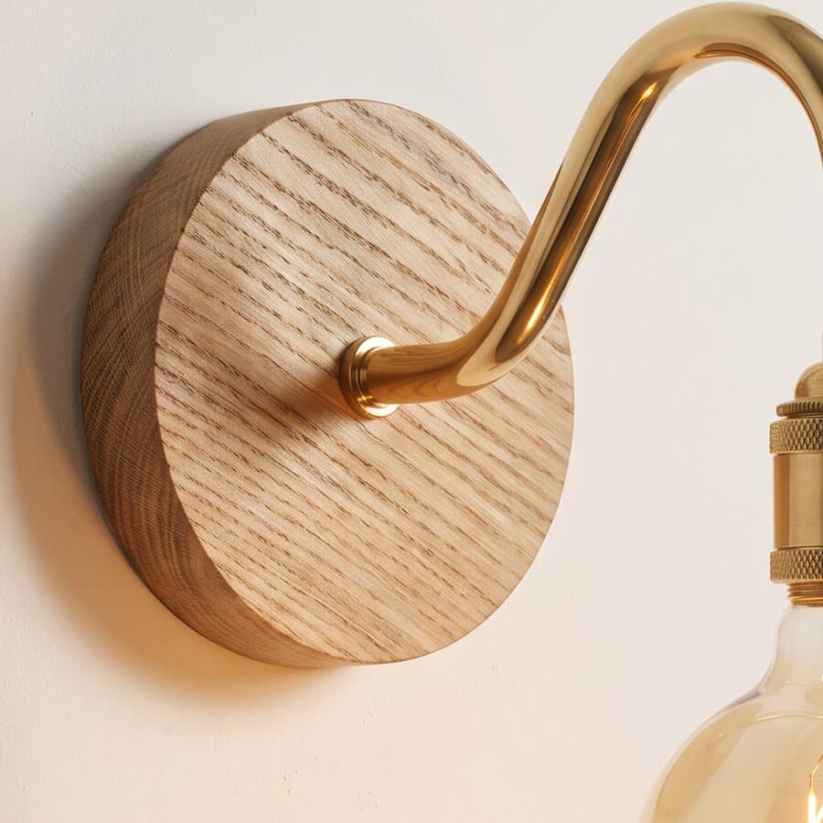 Solid oak back plate of a wall light, showing the turned edge and the grain
