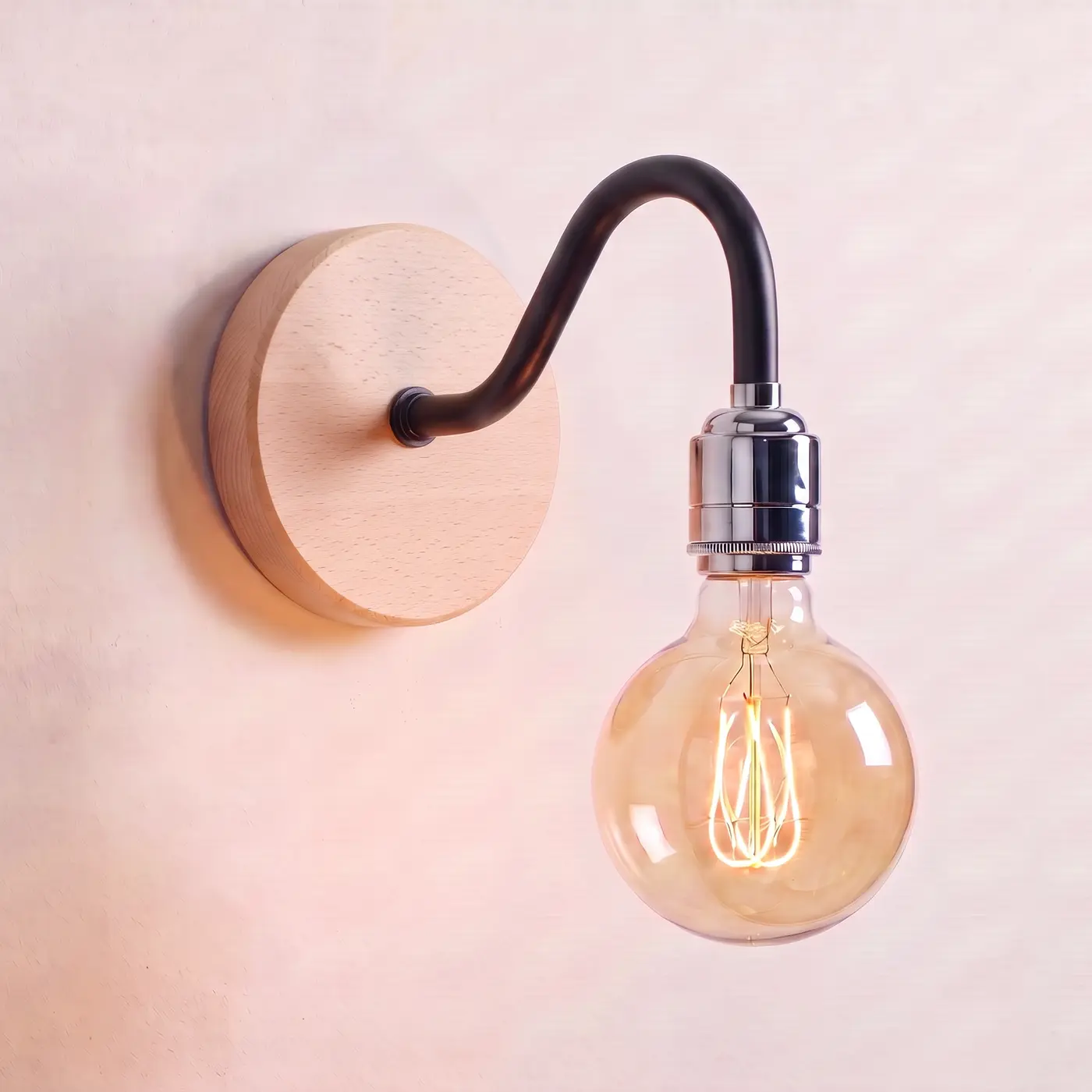 Swan neck wall light with a beech back plate, black swan neck arm and chrome bulb holder, lit with a globe filament bulb