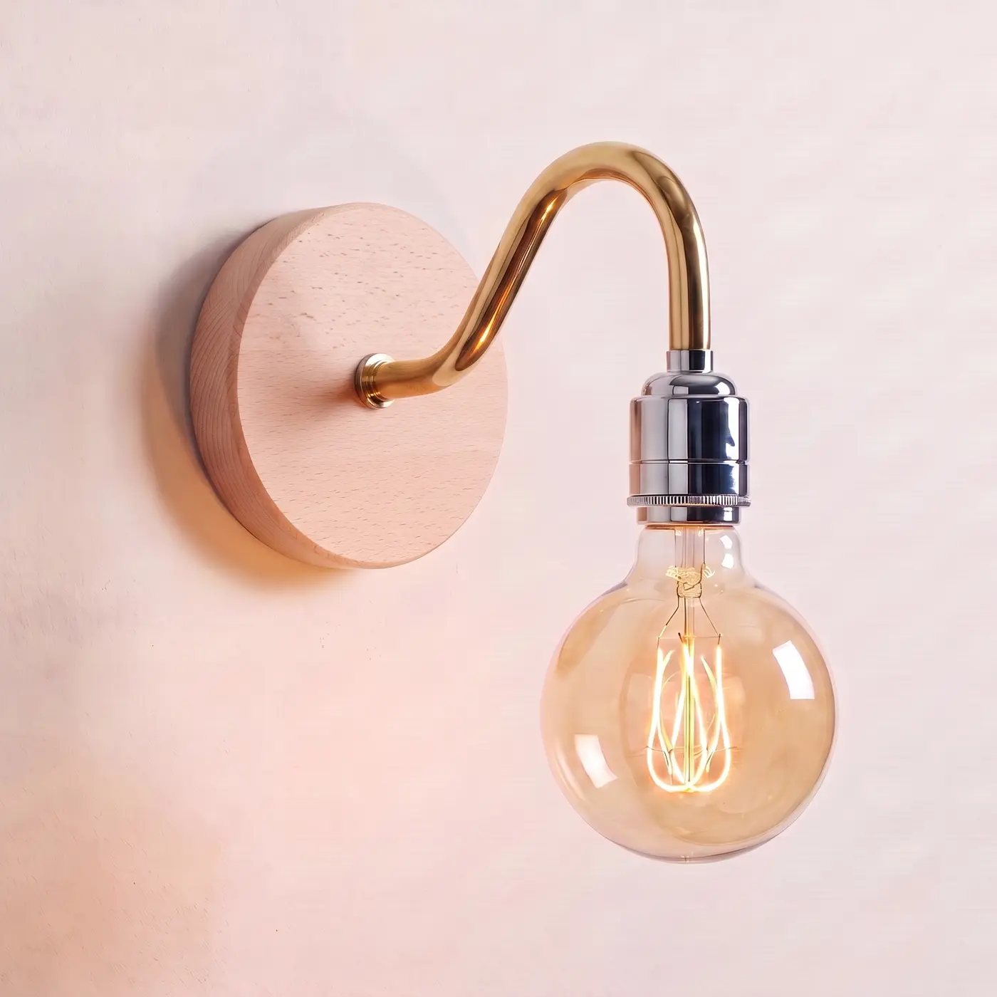 Swan neck wall light with a beech back plate, brass swan neck arm and chrome bulb holder, lit with a globe filament bulb