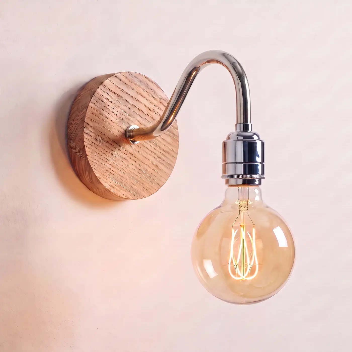 Swan neck wall light with a natural oak back plate, chrome swan neck arm and matching bulb holder, lit with a globe filament bulb