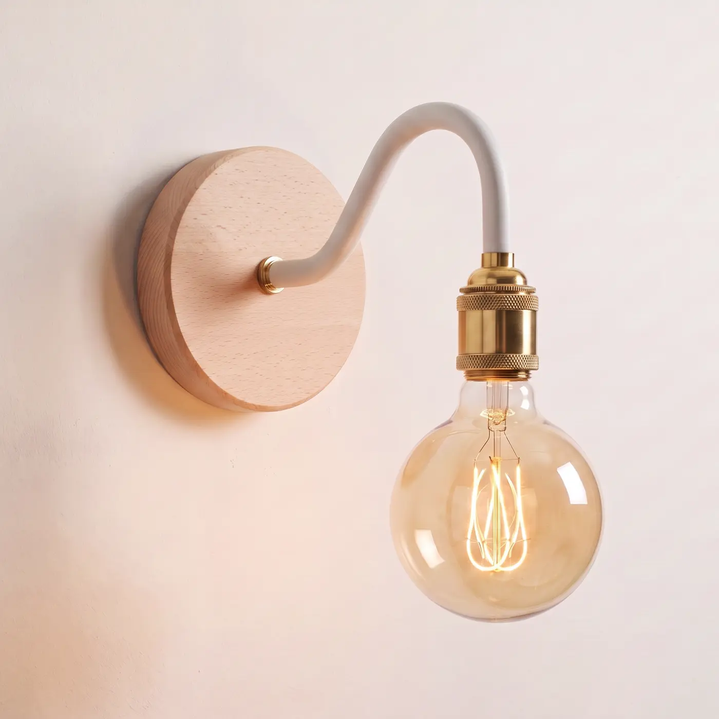 Swan neck wall light with a beech back plate, white swan neck arm and brass bulb holder, lit with a globe filament bulb
