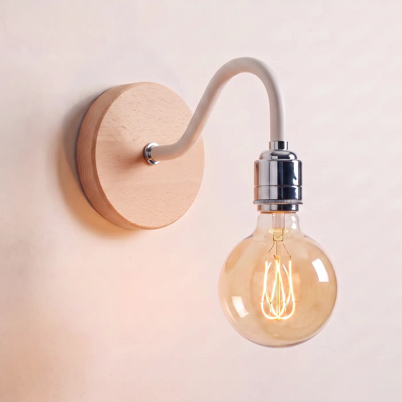 Swan neck wall light with a beech back plate, white swan neck arm and chrome bulb holder, lit with a globe filament bulb